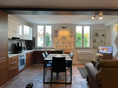 a kitchen with a table and chairs in a room at CANNES SUQUET beautiful Duplex in Cannes