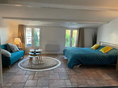 a bedroom with a bed and a couch and a table at CANNES SUQUET beautiful Duplex in Cannes