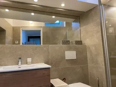 a bathroom with a sink and a mirror at CANNES SUQUET beautiful Duplex in Cannes