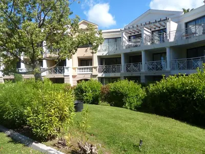 an apartment building with a lawn in front of it at Appartement 4 personnes ,résidence vue mer et jardin, piscine, parking in Cannes