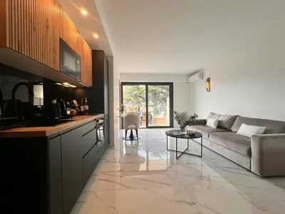 a living room with a couch and a table at Luxury Appartment with terrace and side sea view in Cannes