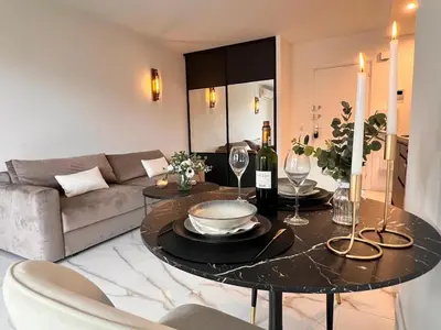 a living room with a table and a couch at Luxury Appartment with terrace and side sea view in Cannes