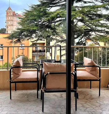 two chairs and a table on a balcony at Luxury Appartment with terrace and side sea view in Cannes