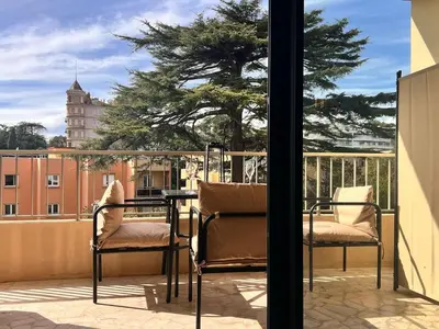 a patio with two chairs and a table on a balcony at Luxury Appartment with terrace and side sea view in Cannes