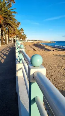 a row of benches next to the beach at Luxury Appartment with terrace and side sea view in Cannes