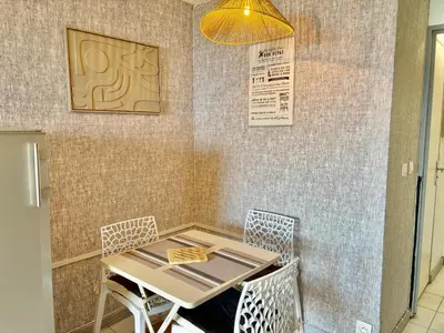 a table and chairs in a restaurant with a light at Palme d'Azur 409 in Cannes