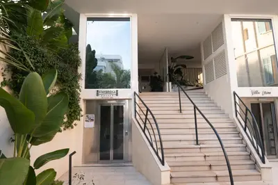 a staircase leading up to a building with plants at 2-bedroom luxurious apartment with balcony and parking in Cannes