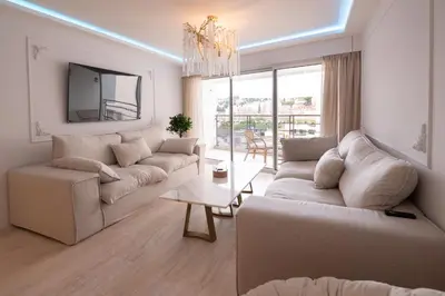a living room with two couches and a table at 2-bedroom luxurious apartment with balcony and parking in Cannes