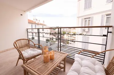 a balcony with a table and chairs and a view at 2-bedroom luxurious apartment with balcony and parking in Cannes