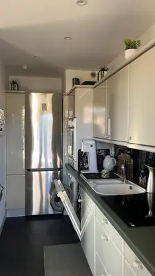 a kitchen with a stainless steel refrigerator and a sink at villa sur le toit au centre de Cannes in Cannes