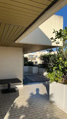 a bench sitting under awning on a patio at villa sur le toit au centre de Cannes in Cannes