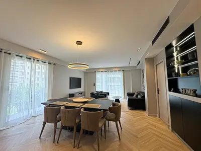 a dining room and living room with a table and chairs at GRAY DUBOY D'ANGERS Luxury 3 bedrooms Croisette in Cannes