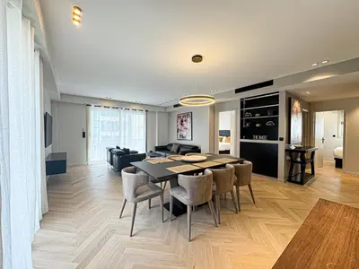 a dining room and living room with a table and chairs at GRAY DUBOY D'ANGERS Luxury 3 bedrooms Croisette in Cannes