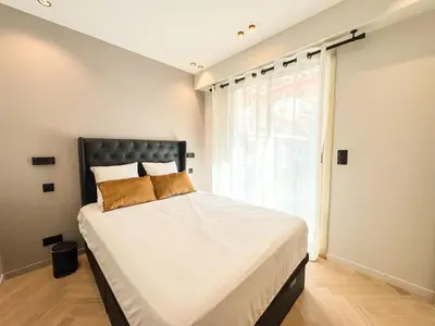 a bedroom with a large bed with a window at GRAY DUBOY D'ANGERS Luxury 3 bedrooms Croisette in Cannes