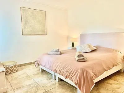 a bedroom with a large bed in a room at Luxurious 2-bedroom Pointe Croisette, Sea view, private parking in Cannes