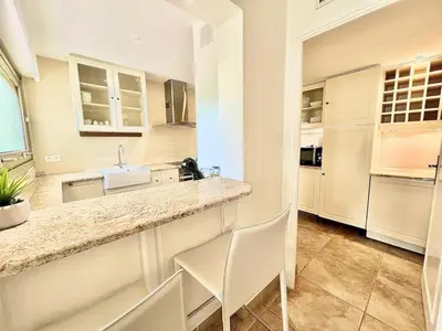 a large kitchen with a counter and a sink at Luxurious 2-bedroom Pointe Croisette, Sea view, private parking in Cannes