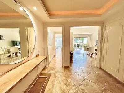 a hallway with a mirror and a dining room at Luxurious 2-bedroom Pointe Croisette, Sea view, private parking in Cannes