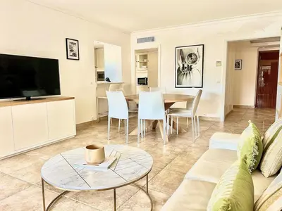 a living room with a couch and a table at Luxurious 2-bedroom Pointe Croisette, Sea view, private parking in Cannes