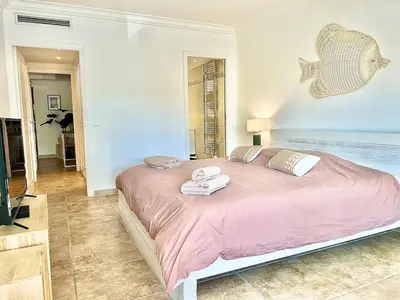 a bedroom with a large bed with towels on it at Luxurious 2-bedroom Pointe Croisette, Sea view, private parking in Cannes