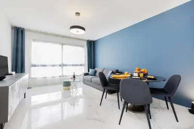 a living room with a table and a couch at Gray d'Albion 3i7 YourHostHelper in Cannes
