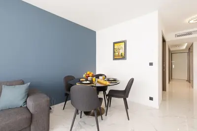 a dining room with a table and a couch at Gray d'Albion 3i7 YourHostHelper in Cannes