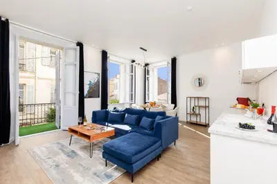 a living room with a blue couch and a table at Modern 3 bedroom apartment ideally located in Cannes