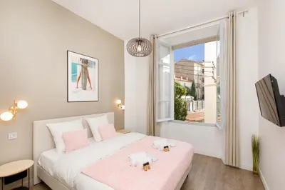 a small bedroom with a bed and a window at Modern 3 bedroom apartment ideally located in Cannes