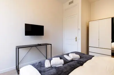 a bedroom with a bed with a mirror and a tv at Modern 3 bedroom apartment ideally located in Cannes