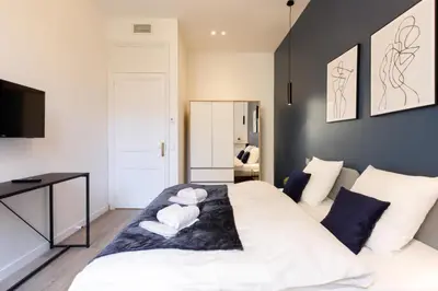 a bedroom with a white bed with towels on it at Modern 3 bedroom apartment ideally located in Cannes