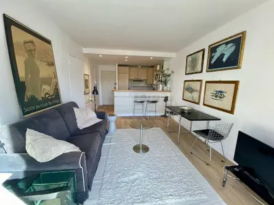 a living room with a couch and a table at Cannes - Latour-Maubourg - 2 P rénové tout confort in Cannes