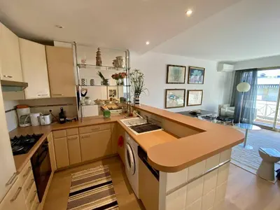 a kitchen with a counter and a stove top oven at Cannes - Latour-Maubourg - 2 P rénové tout confort in Cannes
