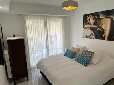 a bedroom with a large bed with two pillows on it at Cannes Centre Mimosas 1 chambre Salon in Cannes