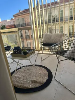 a balcony with a table and chairs on a balcony at Cannes Centre Mimosas 1 chambre Salon in Cannes
