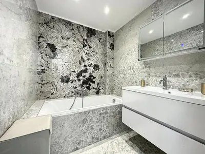 a bathroom with a white tub and a sink at Cannes Centre Mimosas 1 chambre Salon in Cannes