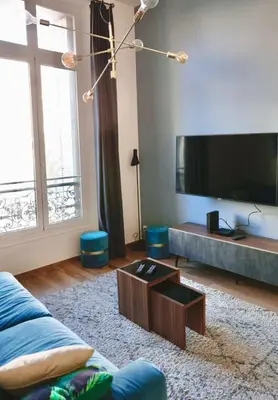 a living room with a large flat screen tv at 2 Pieces bourgeois centre de Cannes 4 couchages une pépite in Cannes