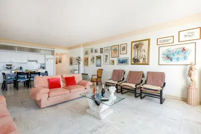 a living room with a couch and chairs and a table at Una Rosa Blu YourHostHelper in Cannes