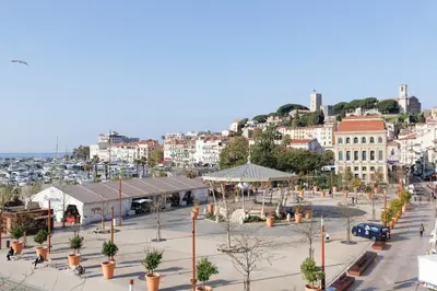 a city with a street with trees and buildings at Una Rosa Blu YourHostHelper in Cannes