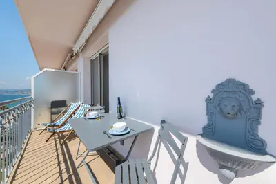 a balcony with a table and chairs on a balcony at Cannes Suquet Sea View & Beach Access in Cannes