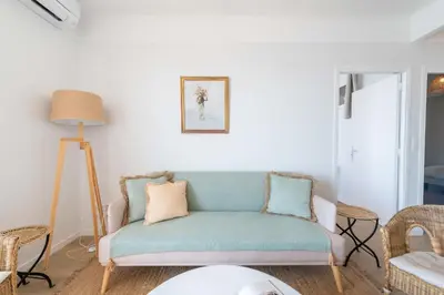 a living room with a couch and chairs at Cannes Suquet Sea View & Beach Access in Cannes