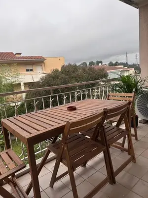 a wooden table and chairs on a balcony at Mont Joli in Le Cannet