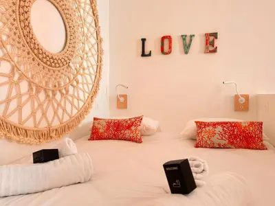 a bedroom with a bed with a mirror on the wall at Casa Bisou Cannes - BOHEME in Cannes