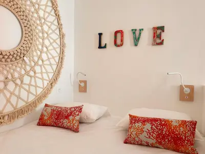 a bedroom with a bed with two pillows and a mirror at Casa Bisou Cannes - BOHEME in Cannes