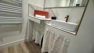 a white bathroom with a sink and a mirror at Casa Bisou Cannes - BOHEME in Cannes