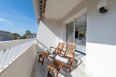 two chairs on the balcony of a house at Spacious 1-Br Apartment with Terrace Heart of Cannes in Cannes