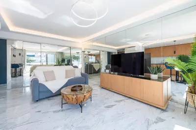 a bedroom with a bed and a tv and a table at Spacious 1-Br Apartment with Terrace Heart of Cannes in Cannes
