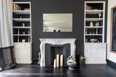 a living room with a fireplace and a mirror at Prestige & Comfort Facing the Palais des Festivals in Cannes
