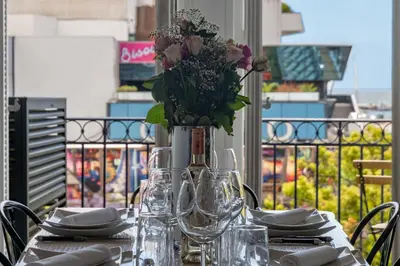 a table with a vase of flowers on top of it at Prestige & Comfort Facing the Palais des Festivals in Cannes