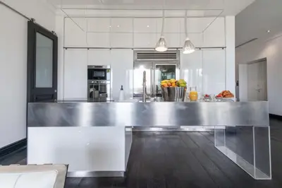 a kitchen with a large stainless steel counter top at Prestige & Comfort Facing the Palais des Festivals in Cannes