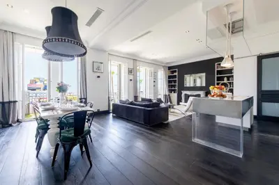 a living room with a table and a couch at Prestige & Comfort Facing the Palais des Festivals in Cannes