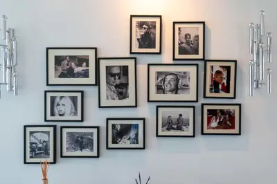 a group of framed pictures on a wall at Prestige & Comfort Facing the Palais des Festivals in Cannes